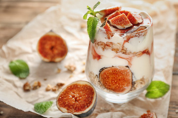 Oatmeal dessert with yogurt and fig in glass on table