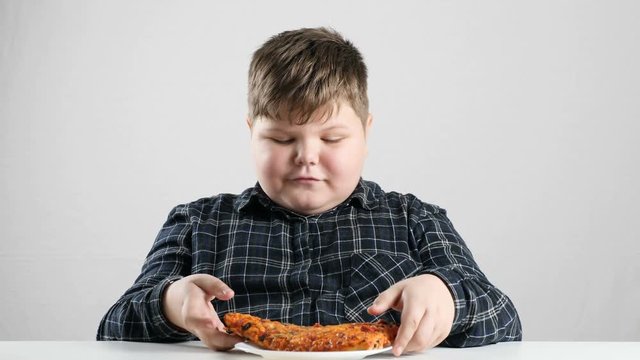Young fat boy eats pizza 50 fps