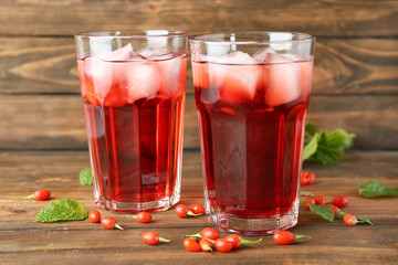 Glasses with goji juice on wooden table
