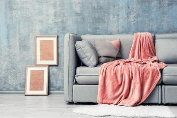 Modern room design with grey sofa