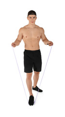 Sporty young man with jumping rope on white background