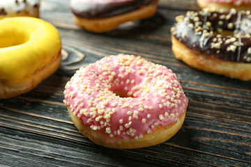 Tasty donuts on wooden table