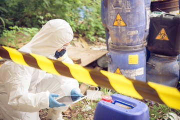 Asian scientist wear Chemical protection suit check danger chemical,working at dangerous...