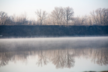 Morning on the river early morning reeds mist fog and water surface on the river