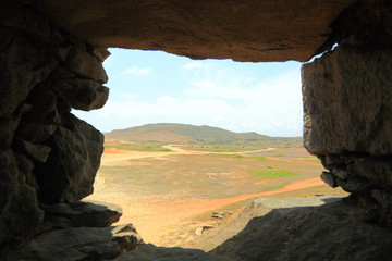 view of the horizon line through a hole in the stone wall, Aruba, north coast