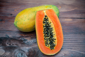 Close up papaya ripe on wooden background,stack photo