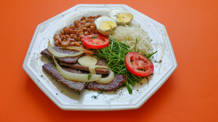 Brazilian food dish on orange background