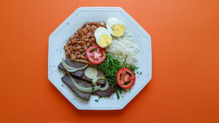 Brazilian food dish on orange background