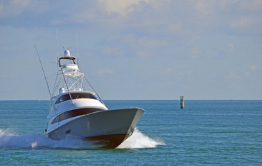 A luxury sport fishing boat returning from a day at sea.