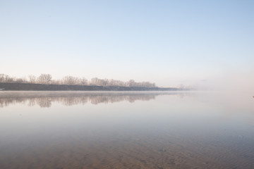 Morning on the river early morning reeds mist fog and water surface on the river