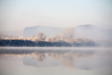 Obraz na płótnie Canvas Morning on the river early morning reeds mist fog and water surface on the river