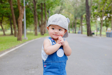 Asian Adorable baby girl playing in park. Beautiful smiling cute baby