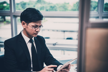 Asian stress business man working fail,The owner of the company blamed him with bad word,Thai employee serious from hard work from boss,Sad handsome guy in black suit