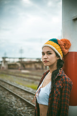 Obraz premium Portrait of hipster girl sit on the railway vintage style,thai woman posing for take a photo