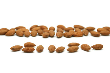 Almond pile lay on white background