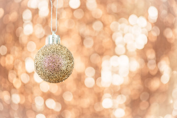 Christmas ball on abstract shimmering bokeh background