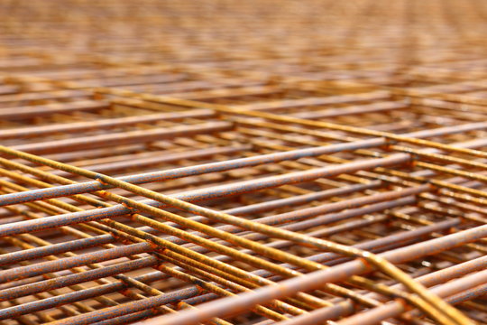 Steel bars for reinforced concrete. Closeup of Steel Bar. Geometric alignment of Re bars on construction site. Rusty is iron rust