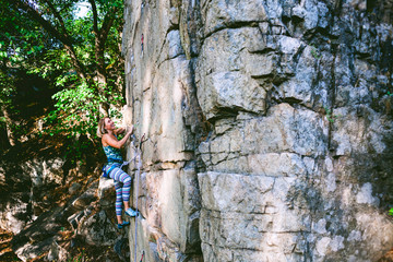 girl climber on a rock.