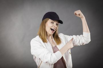 Young woman showing her arm muscles