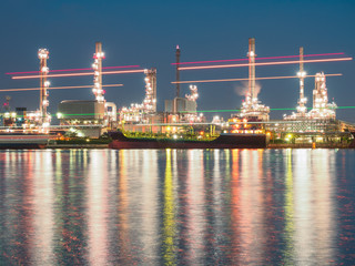 Fototapeta premium long exposure shot of oil refinery plant against blue evening sky