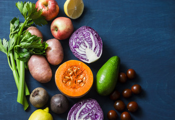 Healthy food vegetables background. Pumpkin, red cabbage, avocado, red onions, kumato tomatoes,...