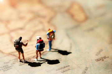 Miniature backpacker on map, Concept of Travel around the world and the adventure.