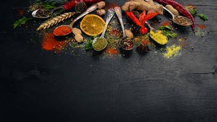 Spices and herbs. A large assortment of spices. Indian cuisine. On the wooden table. Top view. Free space for text.