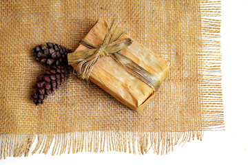 Gift box from banana leaf on white background