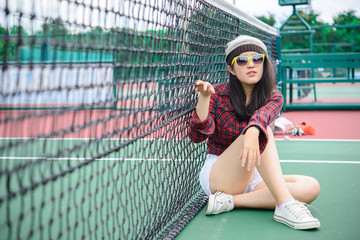 Hipster asian girl pose for take a photo,Fashion portrait pretty woman at tennis court,lifestyle of modern teenage thai girl