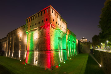 Fototapeta na wymiar Sforza's castle in a multicolored night illumination. Milan, Italy