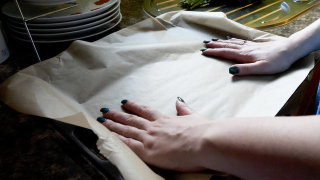 Day View Female Hands Placing Baking Paper On Oven Tray Tin