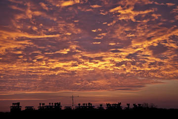 Sunset over the city with red highlighted clouds.Landscape.