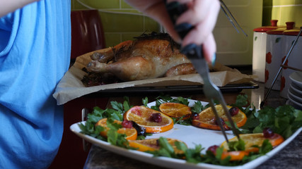 Female Hands Decorate Roasted Whole Chicken on Plate For Family Dinner