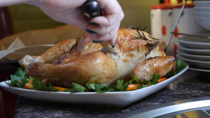 Female Hands Decorate Roasted Whole Chicken on Plate For Family Dinner