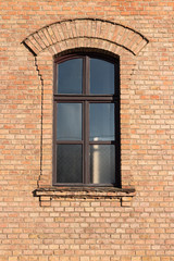 Old brick building with window with little arch above