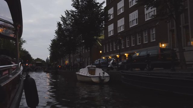 Sailing at dusk and looking at the waters and architecture of Amsterdam.