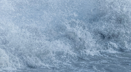 An abstract image of ocean wave water droplets frozen in a fast exposure close up.