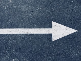 White arrow painted on the asphalt 