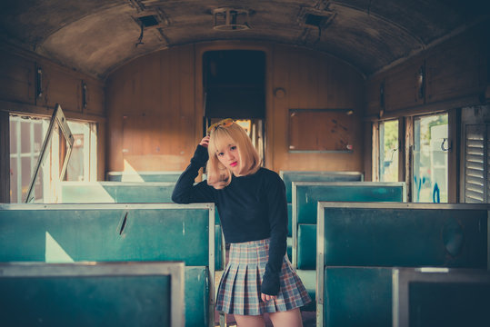 Portrait Of Asian Woman Golden Hair Pose For Take A Photo On Old Train Vintage Style,thailand People,Lifestyle Of Modern Girl