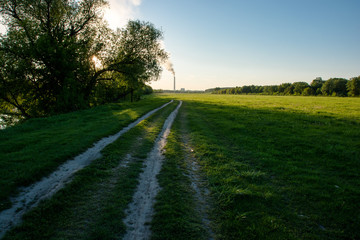 Fototapeta premium Soil roadway far to the field