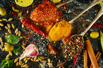 Variety of spices and herb on kitchen table.