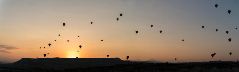 silhouettes of hot air balloons in Cappadocia, Turkey