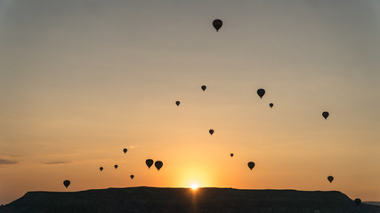 silhouettes of hot air balloons in Cappadocia, Turkey