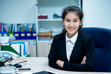 Asian businesswoman working on the desk at office,Thailand worker woman smile,Beautiful secretary has a nice smile,Lady clerk overtime time at the company.