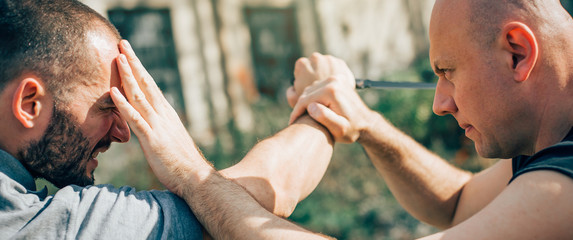 Kapap instructor demonstrates martial arts self defense knife attack disarming