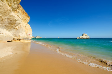 View of limestone cliffs of the Three Castles beach in Portimao. District Faro, Algarve, Southern Portugal