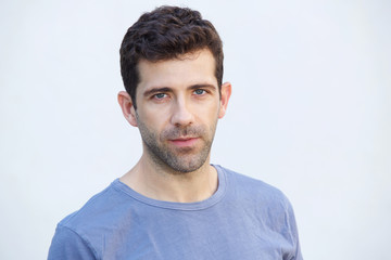 Fototapeta premium Close up serious caucasian man standing on white background