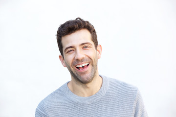 Obraz premium Close up cheerful young man laughing over white background