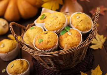 Appetizing and ruddy muffins with pumpkin and walnut.