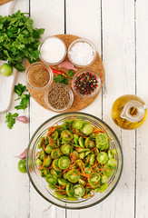 Korean salad from green tomatoes and carrots. Flat lay. Top view